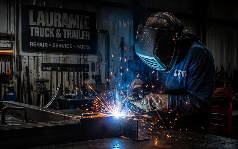 Welder laying a bead with sparks flying in the fab shop